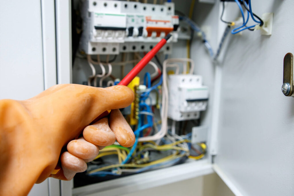 Electrician inspecting circuit breaker