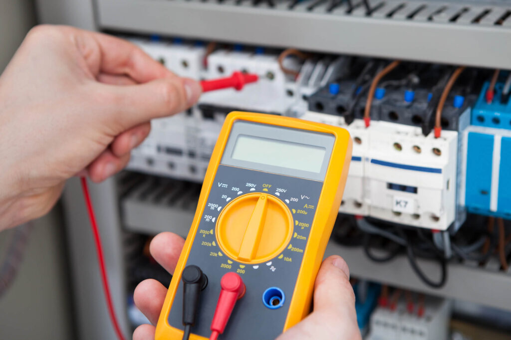Electrician Testing Voltage with Multimeter